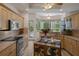 Bright kitchen with wooden cabinets, stainless steel appliances, granite countertops, and a door to the outside at 5072 Abbonmarsh Cir, Brooksville, FL 34604