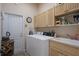 Laundry room includes a washer, dryer, cabinets, and sink at 5072 Abbonmarsh Cir, Brooksville, FL 34604