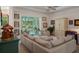 Bright and airy living room featuring an open concept design, neutral tones, and views of the lanai at 5072 Abbonmarsh Cir, Brooksville, FL 34604
