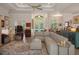 Open living room with neutral sectional, hardwood floors, and an abundance of natural light at 5072 Abbonmarsh Cir, Brooksville, FL 34604