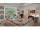 Bright living room featuring a neutral sofa, chairs, artwork, and access to a sunroom at 5072 Abbonmarsh Cir, Brooksville, FL 34604