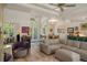 Inviting living room with neutral sectional, vaulted ceilings, and beautiful hardwood floors at 5072 Abbonmarsh Cir, Brooksville, FL 34604