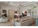 Open-concept living area featuring neutral sofa, chairs, hardwood floors, and abundance of natural light at 5072 Abbonmarsh Cir, Brooksville, FL 34604