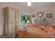 Bedroom featuring wood floors, closet, dresser and views of the pool at 5072 Abbonmarsh Cir, Brooksville, FL 34604