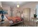 Main bedroom boasting wood floors, en-suite bath, and an elegant lamp at 5072 Abbonmarsh Cir, Brooksville, FL 34604