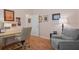 Inviting office with light pink walls, hardwood floors, desk space and comfortable seating at 5072 Abbonmarsh Cir, Brooksville, FL 34604
