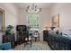 Stylish office space featuring ornate cabinetry, unique light fixtures, and bright natural light at 5072 Abbonmarsh Cir, Brooksville, FL 34604