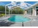 Screened in pool area with a pool, spa, water features and outdoor seating at 5072 Abbonmarsh Cir, Brooksville, FL 34604