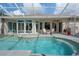 Screened in pool area with a pool, outdoor seating and access to the home at 5072 Abbonmarsh Cir, Brooksville, FL 34604