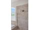 The glass shower features decorative tile and a shower head at 5072 Abbonmarsh Cir, Brooksville, FL 34604
