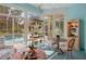 Sunroom with pool view, plant stand, breakfast nook, and light blue walls at 5072 Abbonmarsh Cir, Brooksville, FL 34604