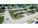 Aerial view of a neighborhood featuring sidewalks, lush trees, and residential properties at 5543 Moog Rd, New Port Richey, FL 34652