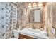 Stylish bathroom featuring a modern vanity, decorative tile, and a framed mirror at 5543 Moog Rd, New Port Richey, FL 34652
