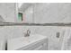Modern bathroom with elegant marble tiling, a sleek vanity, and a stylish mirror at 5543 Moog Rd, New Port Richey, FL 34652