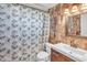 Bathroom featuring a modern vanity, decorative tile, and a framed mirror and shower at 5543 Moog Rd, New Port Richey, FL 34652
