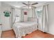 Bedroom with hardwood floors, ceiling fan, and two large windows providing natural light at 5543 Moog Rd, New Port Richey, FL 34652