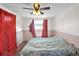 Cozy bedroom with hardwood floors, a window, and red curtains allowing for natural light at 5543 Moog Rd, New Port Richey, FL 34652