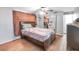 Comfortable bedroom with hardwood floors, a ceiling fan, and ample closet space at 5543 Moog Rd, New Port Richey, FL 34652