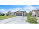 Well-maintained single-Gathering home with a long driveway, one-car garage, and minimal landscaping at 5543 Moog Rd, New Port Richey, FL 34652