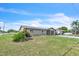 Charming single-story home with an attached garage and a front yard featuring green grass and landscaping at 5543 Moog Rd, New Port Richey, FL 34652