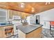 Well-equipped kitchen with an island, plenty of cabinets, modern appliances, and a unique wooden ceiling at 5543 Moog Rd, New Port Richey, FL 34652