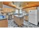 Bright kitchen featuring a center island, stainless steel appliances and a distinctive wood plank ceiling at 5543 Moog Rd, New Port Richey, FL 34652