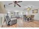 Bright and airy living and dining areas with wood-look floors, comfortable seating, and a ceiling fan at 5543 Moog Rd, New Port Richey, FL 34652