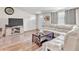 Inviting living room with wood-look floors, a comfortable sofa, and a media center for entertainment at 5543 Moog Rd, New Port Richey, FL 34652