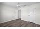 Bright bedroom with gray vinyl flooring, dual closets, and two entry doors at 5555 Baffin Cir, Spring Hill, FL 34606