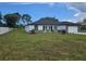 Charming single-story home with a manicured lawn, stone accents, and an attached garage at 5555 Baffin Cir, Spring Hill, FL 34606