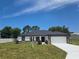 Inviting home exterior with well-maintained landscaping, stone details, and a pristine driveway at 5555 Baffin Cir, Spring Hill, FL 34606