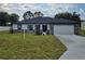 Beautiful single-story home with manicured lawn, two-car garage, stone accents and neutral paint at 5555 Baffin Cir, Spring Hill, FL 34606