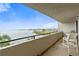 Balcony with seating, offering panoramic views of the bay and nearby residential area at 6035 Sea Ranch Dr # 410, Hudson, FL 34667