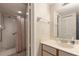 Bathroom featuring white tiled walk-in shower with safety bar and vanity with updated faucet at 6035 Sea Ranch Dr # 410, Hudson, FL 34667
