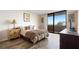 Serene bedroom with sliding glass door to balcony offering views and natural light; features laminate flooring at 6035 Sea Ranch Dr # 410, Hudson, FL 34667
