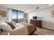Comfortable bedroom with sliding glass door to balcony offering views and natural light; features laminate flooring at 6035 Sea Ranch Dr # 410, Hudson, FL 34667