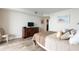 Cozy bedroom with laminate flooring and sliding glass door to balcony offering views and natural light at 6035 Sea Ranch Dr # 410, Hudson, FL 34667