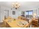 Bright dining area adjacent to the living room, featuring a sliding glass door to the balcony at 6035 Sea Ranch Dr # 410, Hudson, FL 34667