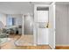 Hallway featuring stacked washer and dryer, tile entry and natural lighting at 6035 Sea Ranch Dr # 410, Hudson, FL 34667