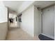 Well-lit condo hallway with tile flooring, neutral walls, and convenient access to unit entrance at 6035 Sea Ranch Dr # 410, Hudson, FL 34667