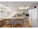 Well-maintained kitchen featuring white appliances, plenty of counter space, and a breakfast bar at 6035 Sea Ranch Dr # 410, Hudson, FL 34667