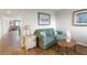 Cozy living room area with love seat, accent tables, and neutral walls at 6035 Sea Ranch Dr # 410, Hudson, FL 34667
