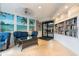 Inviting lobby area with comfortable seating, a bookshelf, and a picturesque mural of a serene beach scene at 6035 Sea Ranch Dr # 410, Hudson, FL 34667