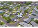 Community aerial view showing homes with carports, set within a well-maintained, tree-lined neighborhood at 6702 Dartmoor Ln # 7A, New Port Richey, FL 34653