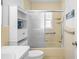 The bathroom has a shower/tub combo with sliding glass doors and a white vanity at 6702 Dartmoor Ln # 7A, New Port Richey, FL 34653