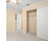 A simple bedroom with a double closet and neutral carpet at 6702 Dartmoor Ln # 7A, New Port Richey, FL 34653