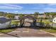 Community entrance with wooden bridge and landscaping on a sunny day at 6702 Dartmoor Ln # 7A, New Port Richey, FL 34653