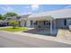 This is a single-story home with a covered carport and a well-maintained lawn at 6702 Dartmoor Ln # 7A, New Port Richey, FL 34653
