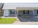 Charming single-story home featuring a covered carport, well-maintained landscaping, and neutral exterior paint at 6702 Dartmoor Ln # 7A, New Port Richey, FL 34653
