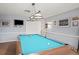 Inviting game room featuring a well-lit pool table, neutral walls adorned with framed art, and a cozy atmosphere at 6702 Dartmoor Ln # 7A, New Port Richey, FL 34653